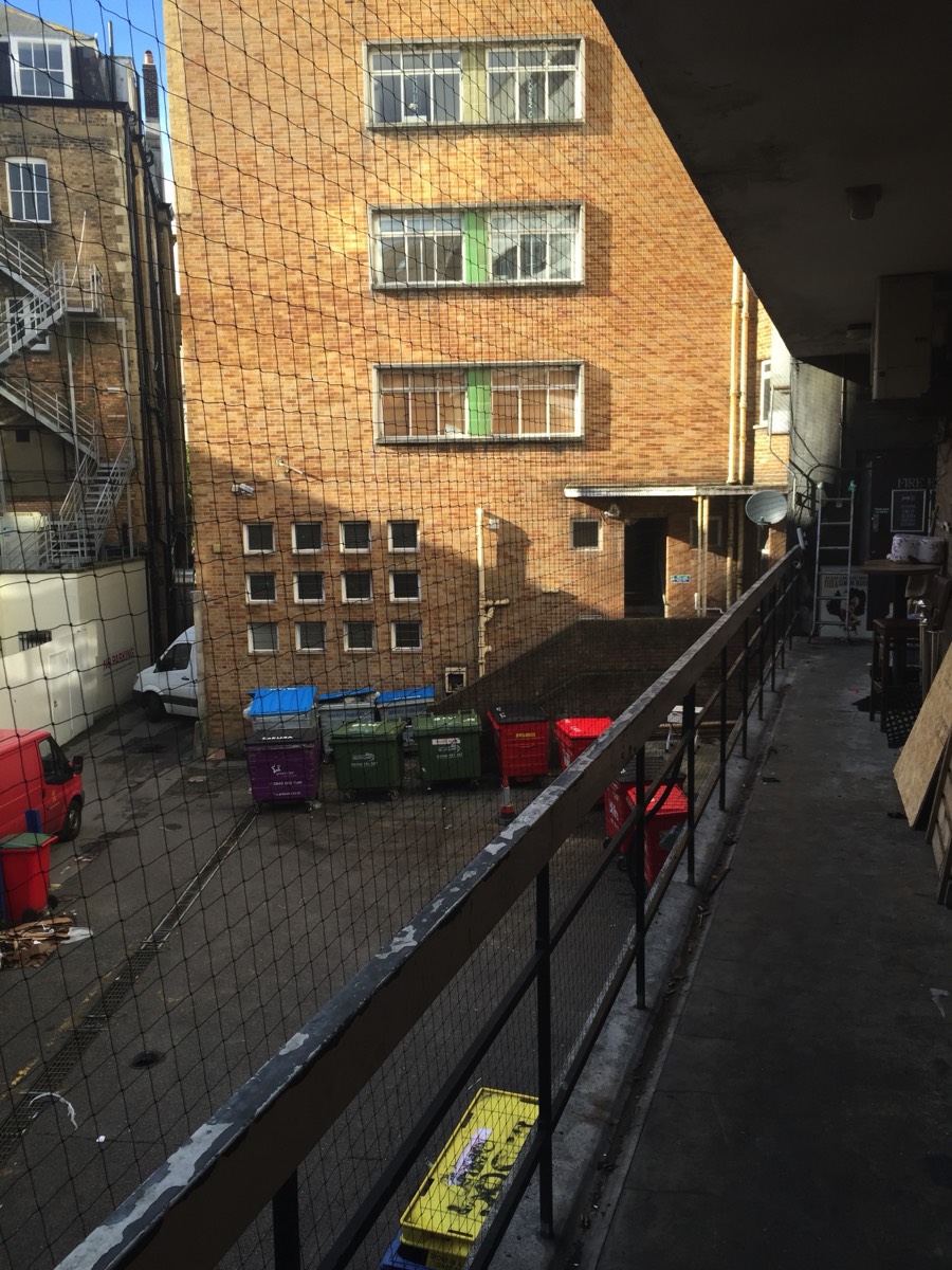 Netting used to prevent Pigeons from gaining access to to a walkway at the rear of a restaurant in Bournemouth. 